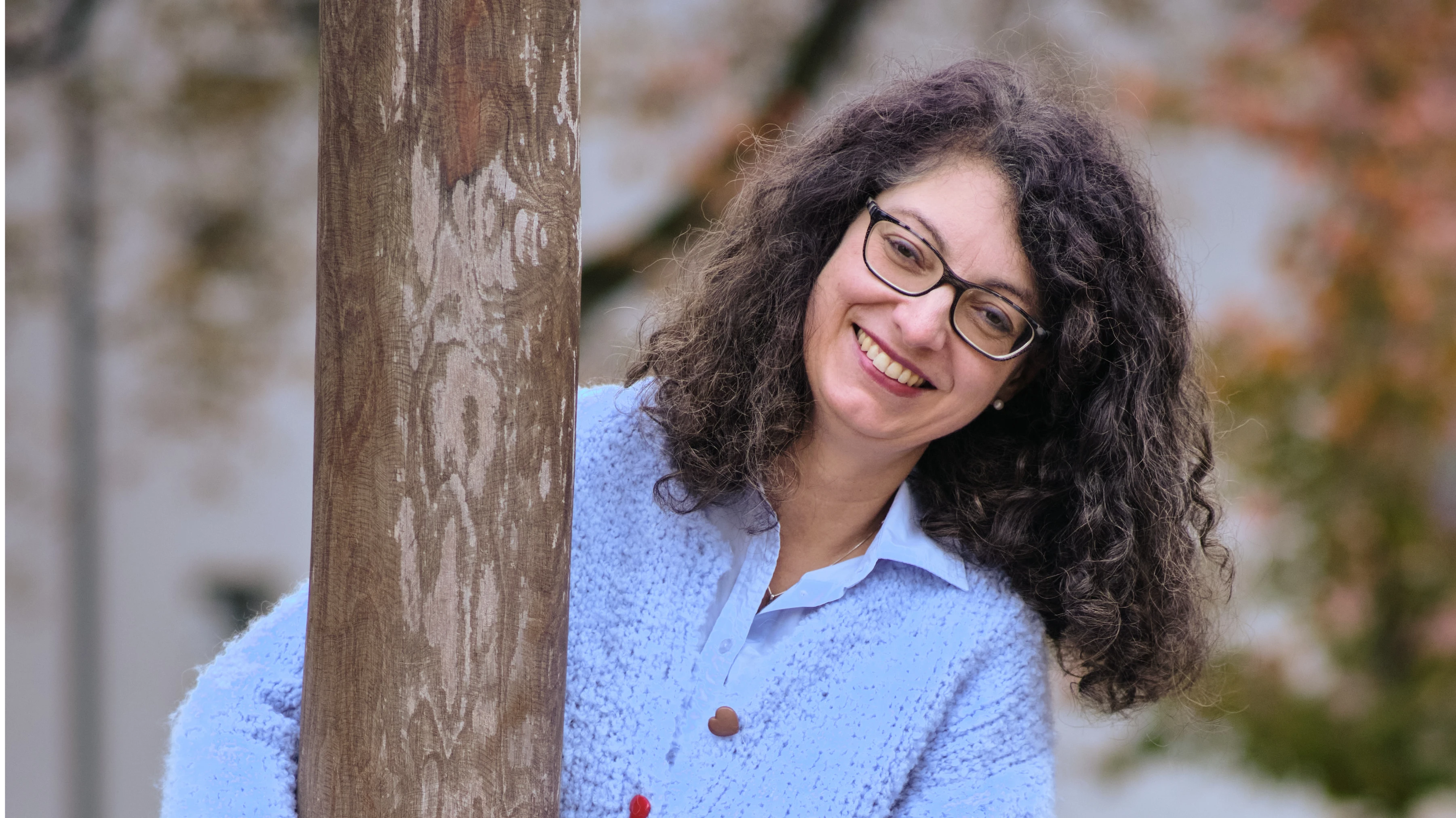 A woman sitting in front of her laptop and smiling